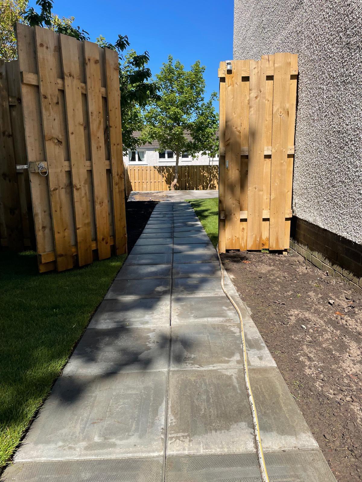 side alley slabbed pathway to summerhouse plinth